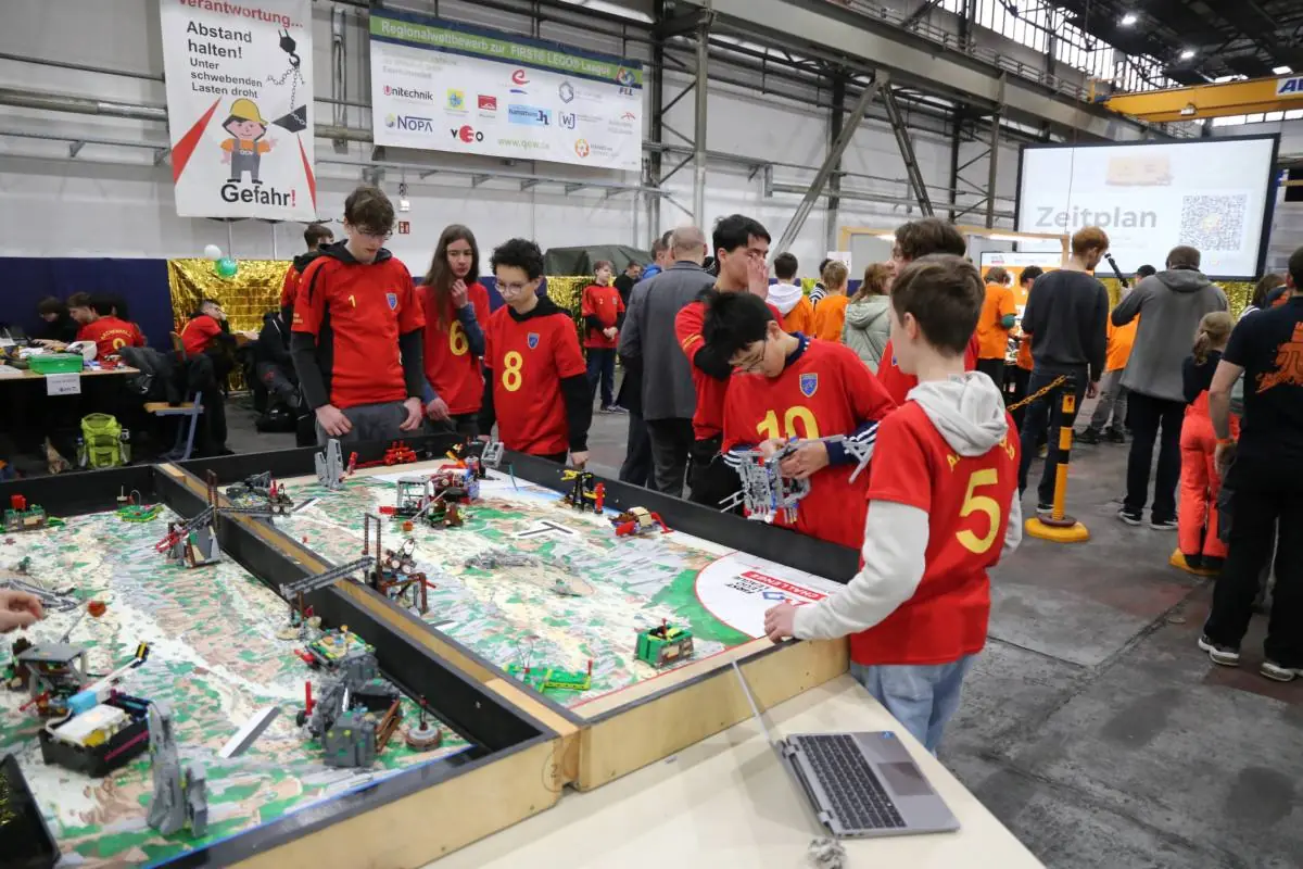 Team working at the FIRST LEGO League competition table